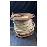 Large spool of white insulated electrical