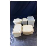 Five plastic food storage containers in a variety