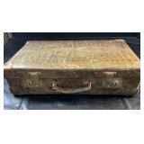 Old-fashioned hard-sided suitcase featuring a