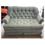 Light green upholstered loveseat featuring deep