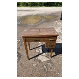 Woodgrain sewing machine cabinet featuring a