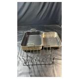 Two rectangular metal roasting pans with handles,