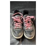 Pair of Nike grey and black sneakers with pink