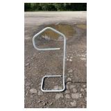 White tubular metal floor stand with an open