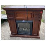 Freestanding electric fireplace featuring a dark