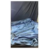 Blue blanket with navy blue stripes, possibly