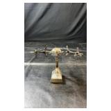 Metal four-propeller airplane model displayed on