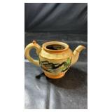 Decorative ceramic teapot with painted landscape