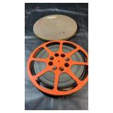 Large reel of 16mm film housed in a metal