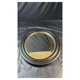 Large round wall mirror with a wide black frame