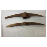Two heavy metal pickaxe heads in different
