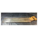 Traditional hand saw with wooden handle and steel
