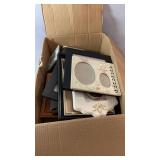 Box containing a variety of picture frames in