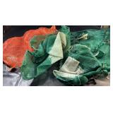 Orange and green mesh potato sacks with