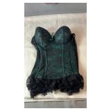 Green corset with black floral lace overlay,