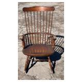Traditional wooden rocking chair with a tall