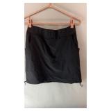 Black ACX active skort in size Medium with a