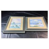 Two framed coastal seascape pictures featuring