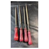 Set of four metal hand files with red wooden