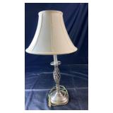Decorative metal table lamp with an open twisted