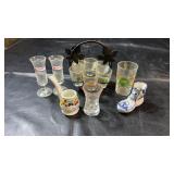 Collection of souvenir drinking glasses and shot