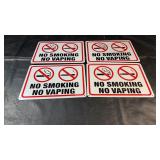 Four matching ï¿½No Smoking No Vapingï¿½ signs with