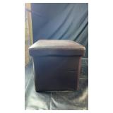Brown faux-leather storage ottoman with a padded