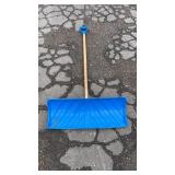 Wide blue plastic snow shovel featuring a long