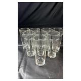 Set of eight clear drinking glasses featuring the