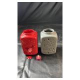 Two ceramic Christmas candle lanterns featuring