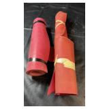 Two rolls of red rubber-like sheet material in