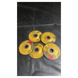 Five DeWalt grinding wheels for use with