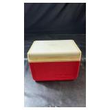 Compact Coleman cooler featuring a red body with