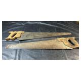 Two traditional hand saws with wooden handles and