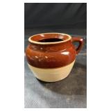 Brown and cream glazed stoneware crock with a