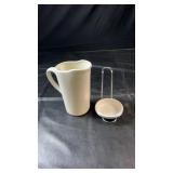 White ceramic milk jug with a small ceramic bowl