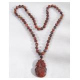 Beaded brown stone w carved pendant