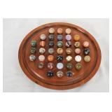 Collection of marble puzzle in wood tray