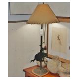 A Wrought Iron Cowboy Lamp with Shade