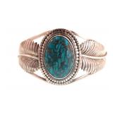 A Navajo Royston Turquoise Bracelet with feathers