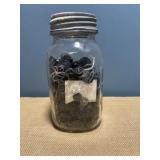 Ball mason jar with sink lid full of black
