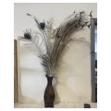 Metal vase with peacock feathers