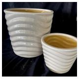 Two creamy white glass planters