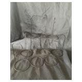 10 ornament hangers that sit on a table