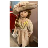 Porcelain doll stands about 30 inch tall
