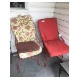 2 red outdoor chairs with cushions