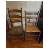 Two ladder back came bottom chairs