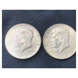 Two silver Kennedy half dollars