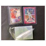2 baseball cards and sleeves