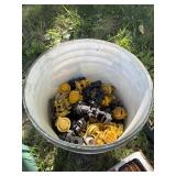 Bucket of electric fence insulators